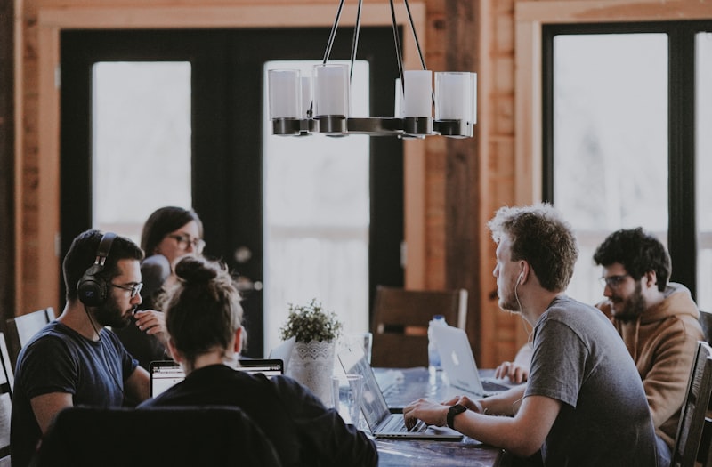 Business professionals collaborating at computers